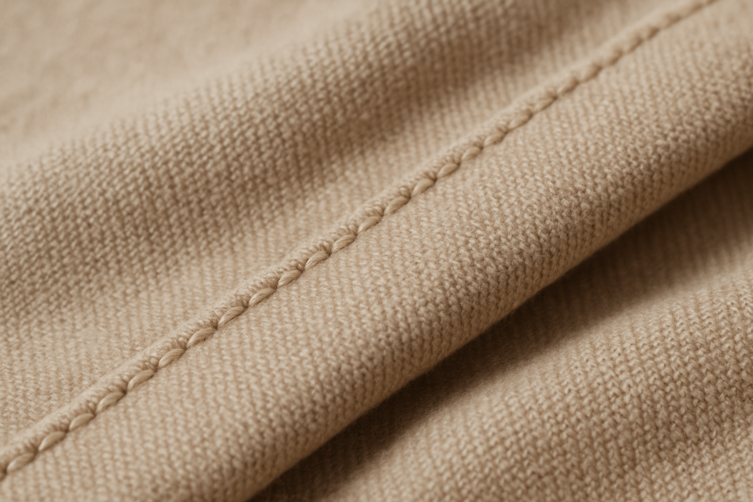A closeup detail shot of premium fabric organic cotton or wool with clean stitching highlighting craftsmanship